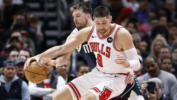 Dallas Mavericks guard Luka Doncic (77) defends against Chicago Bulls center Nikola Vucevic (9) during the second half at United Center.